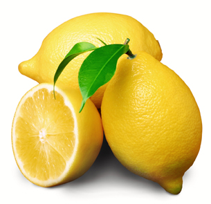 This photograph shows two whole lemons and one lemon that is sliced in half. 