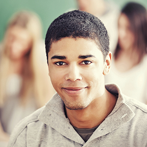This photo shows a young man smiling.