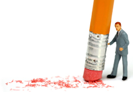 This shows a photo of a miniature toy man posing with the eraser end of a pencil.