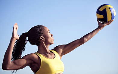 This shows a photo of a woman preparing to serve a volleyball.