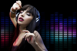 This shows a photo of a young woman wearing headphones and dancing to the music. The background is black with various coloured cells that resemble a graphic equalizer display.