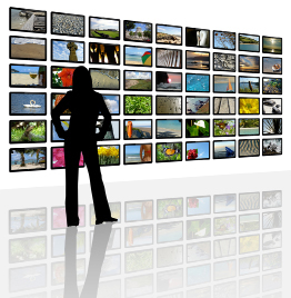 This shows an illustration of the silhouette of a woman facing a bank of 54 television screens. The screens show images of tropical landscapes.