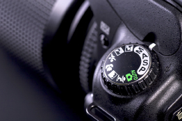 This shows a close-up photo of the dial on a digital SLR camera.