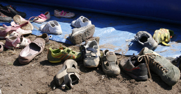 This shows a photo of various shoes scattered on the ground.