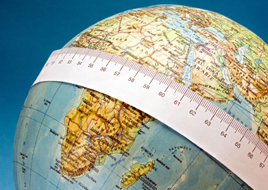 This is a photo showing a measuring tape around the middle of a globe.