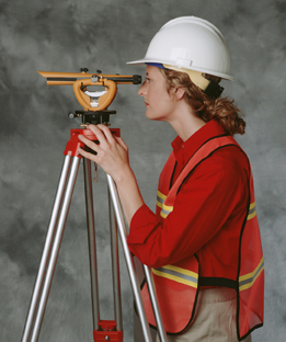 This is a photo showing a woman using a theodolite to measure horizontal and vertical angles.