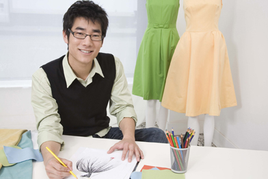 This is a photo of a fashion designer designing a ball gown.