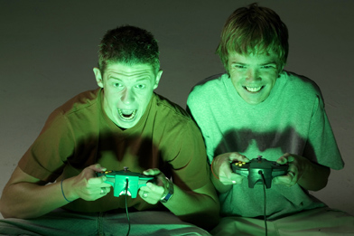 This is a photo of a two teen boys playing video games.