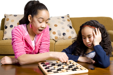 This is a photo of two girls playing checkers.