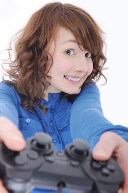 This is a photo of a teenage girl holding a video game control.