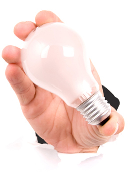 This is a photo of a hand holding a light bulb.