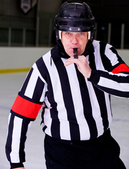 This photo is of a hockey referee in a rink.