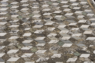 This is a photo of a tile illusion on an old floor.