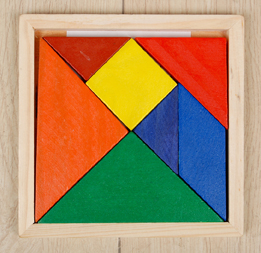 This is a photo of a tangram puzzle in a wooden box.