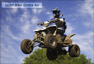This shows a photo of a quad jumping into the air.