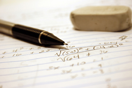 This photo shows a pencil and an eraser and a handwritten radical sign on a piece of paper.