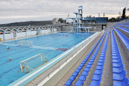 This photo shows a swimming pool with diving towers.