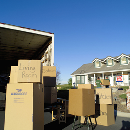 This is a photo of people moving boxes to a moving truck.