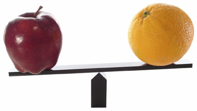 This photo shows an apple on one end of a balance beam and an orange on the other end.