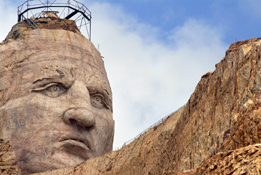 This is a photo of Crazy Horse’s face carved into the stone on the side of a mountain.