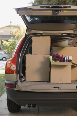 This is a photo of the back of a car packed with moving boxes.