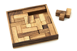 A photo shows a wooden pentominoes game.