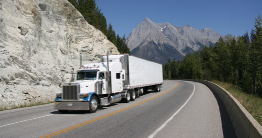 This is a photo of a tractor-trailer unit driving on a highway.