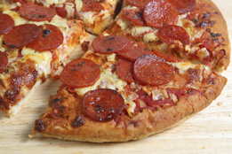 This is a photo of a pepperoni pizza cut into four slices.