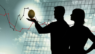 This image shows a silhouette of a couple against a background of a cloudy sky and a broken-line graph. The man is holding a glowing nest egg in his hand.