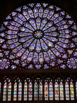 This is a photo showing the stained glass rose window in Notre Dame cathedral, Paris, France. 