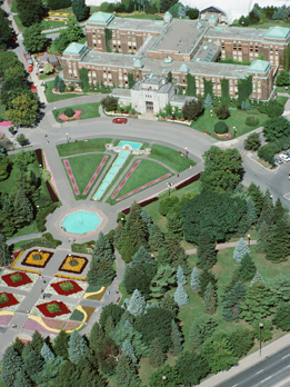 This shows an illustration a bird’s-eye perspective of the landscape design of a residential property. Included are a variety of trees and plants amongst the fountain and pond. There are also two gazebos and a path made of different materials around the perimeter of the property.