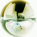 This shows a photo of a business plaza through a fish-eye lens.