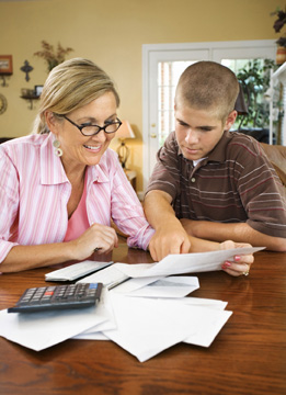 In this photo, two people look through bills.