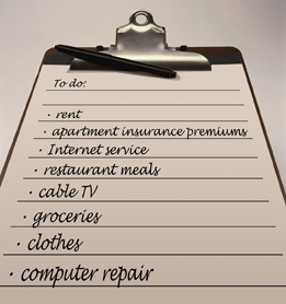 This photo is of a list of living expenses written on a clipboard.