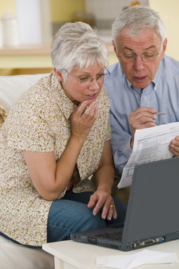 A senior couple review their budget in this photo.