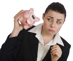 In this photo a woman looks at her piggybank. 
