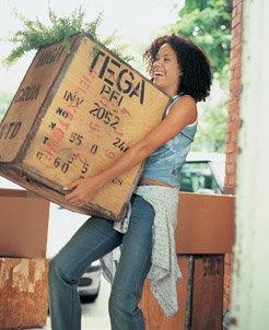 In this photo a woman is shown moving boxes.