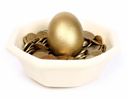 This photo is of a golden egg in a nest of golden coins.