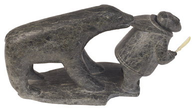 This photo is of an Inuit carving of a bear and a hunter.