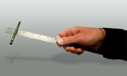 This is a picture of a pencil on a ruler with one end lifted.