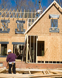 This image is of people building the roof of a house.