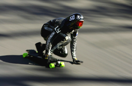 This is a photo of a skateboarder racing downhill.