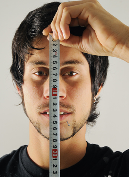 This photo shows a man measuring the height of his face.