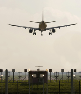 This is a photo of an airplane approaching a runway.
