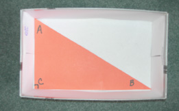 A right triangle ABC is on the bottom of the box.