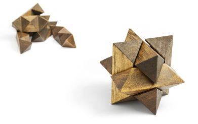 This is an image of a wooden three-dimensional star-shaped puzzle.