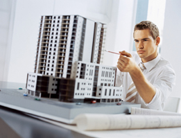 This is a photo of an architect preparing a scale model of a building.