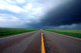 This is a photo of a prairie highway converging to a point on the horizon.
