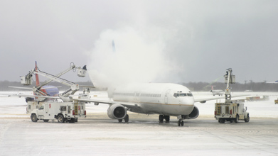 This is a photo of two trucks de-icing an aircraft.
