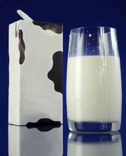 A glass of milk and a litre milk container are in this photograph.
